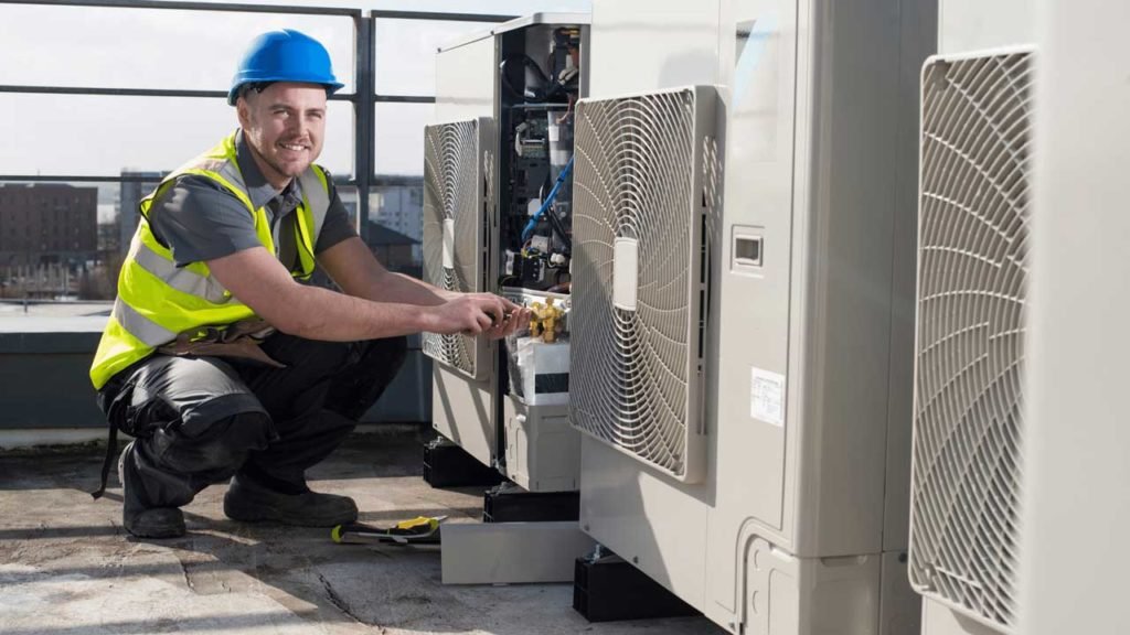 HVAC technician repairing an outdoor air conditioning unit